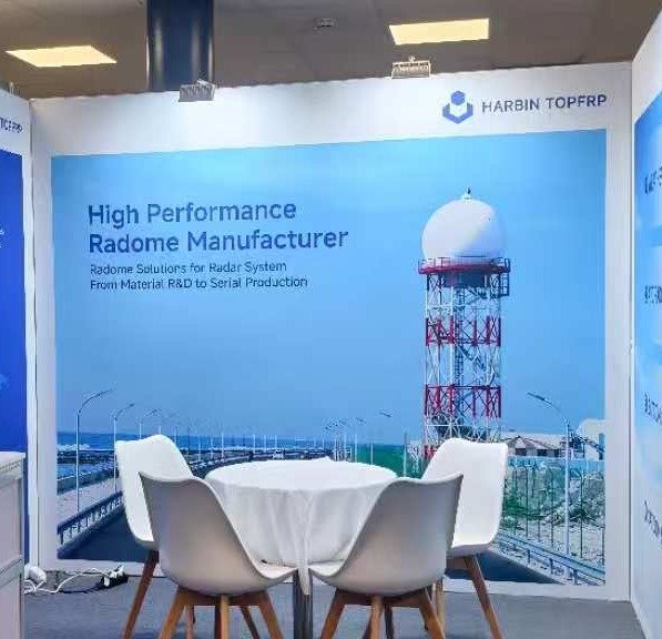 High performance radome manufacturer booth backdrop with weather radar tower radome at stand F07, Amsterdam 2026