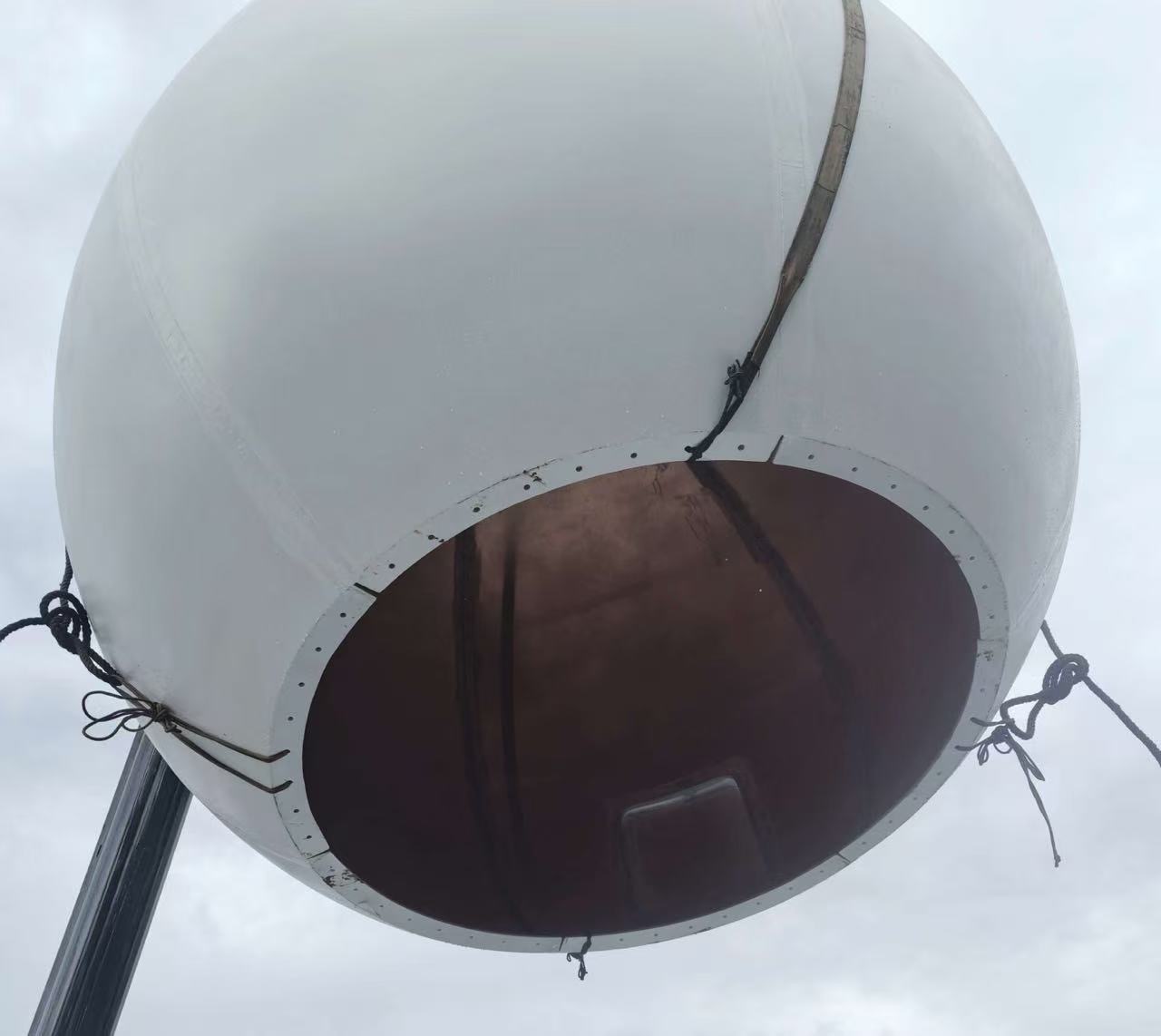 4.6 m Ka-band radome being lifted by crane, bolted base flange ring visible